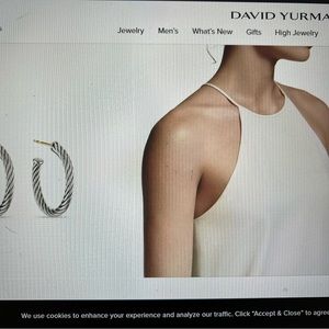 Half of a pair of David Yurman cable Hoop earrings